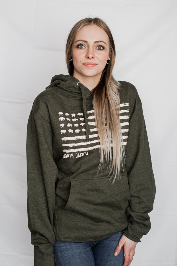 A mid-weight Army Heather colored hooded sweatshirt with pouch front. The front graphic resembles the U.S. flag with images of grazing Bison in the stars field. The words North Dakota are placed directly under the graphic.