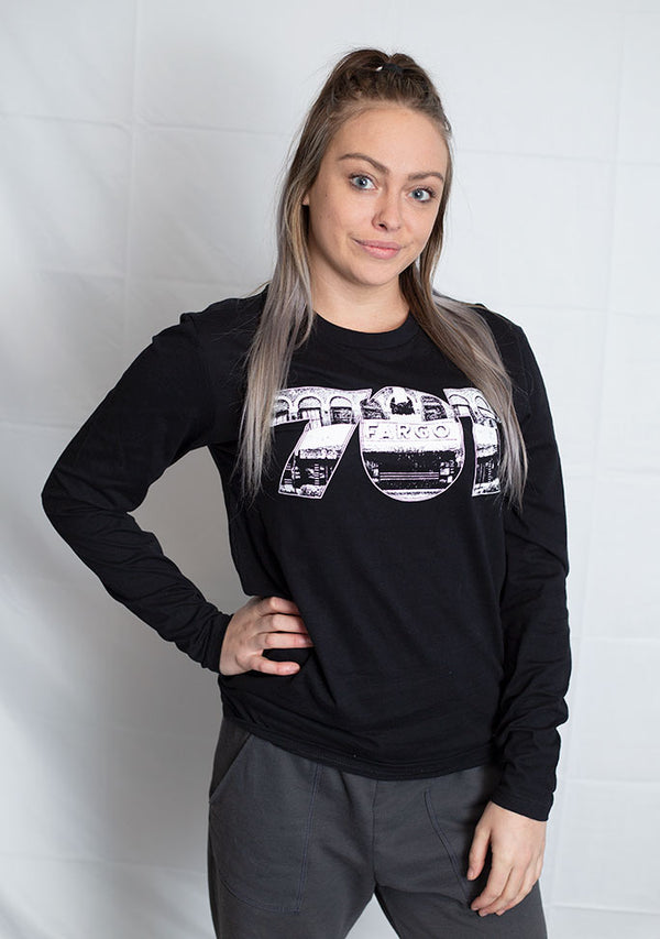 A Black long sleeved tee with white graphic. the numbers 701 with  the Fargo Theater appear on the front of the shirt.