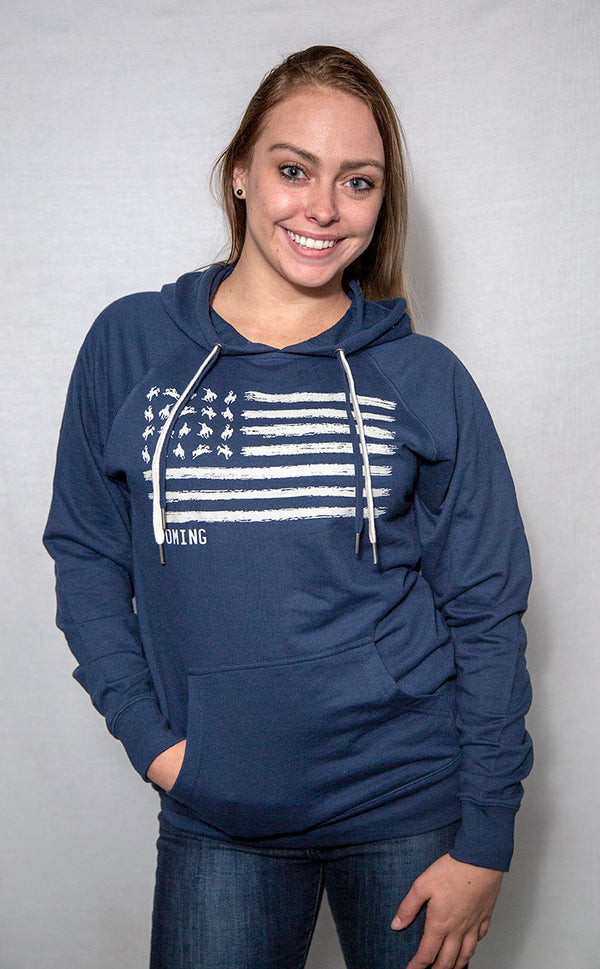 A mid-weight Cool Blue colored hooded sweatshirt with pouch  front and contrasting drawstrings. The graphic resembles the U.S. flag with images of Bucking Broncos in the stars field. The word WYOMING is placed directly under the graphic.