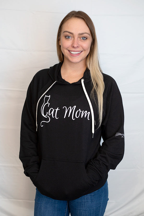 Black hooded pouch front sweatshirt with Cat Mom written in white. Cat nose and whiskers are on the left sleeve. 