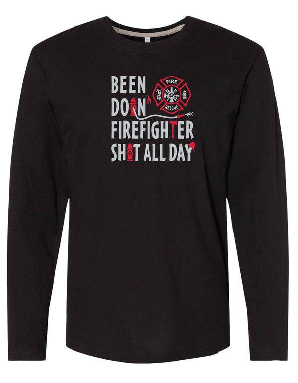 Black long sleeved tee is 100% ring spun cotton. The shirt has white and red graphic  saying BEEN DOIN' FIREFIGHTER SHIT ALL DAY IMPRINTED ON FRONT. Designed by Scratchpad Tees. Sizes Small to 3XL