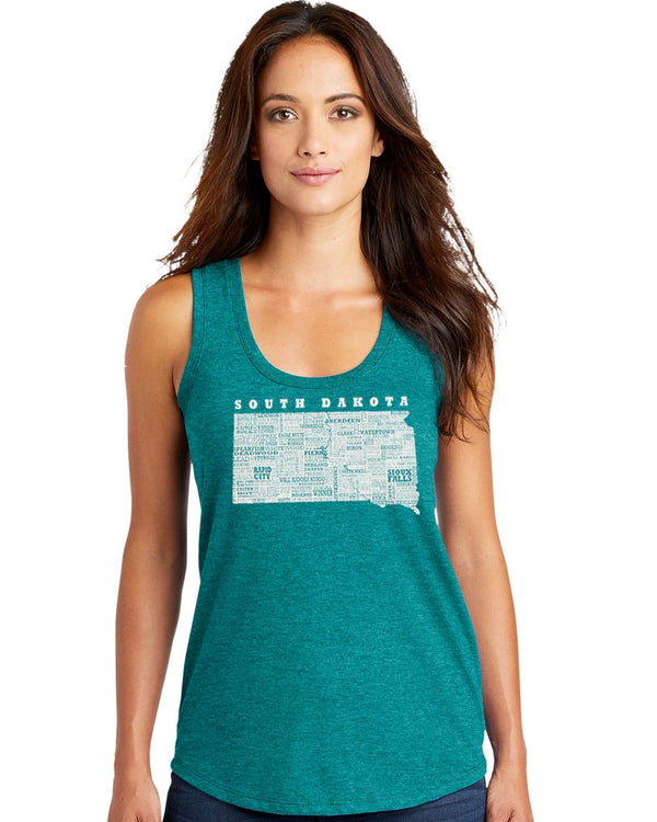 A woman wearing a Heather Teal colored, racerback, Tri-blend tank top with a light grey design of the state of South Dakota and its cities on the front. Available in sizes Extra Small to 2X-Large.