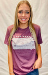 A woman wearing a unisex sized, Heather Maroon crew neck, cotton polyester, short sleeve tee. Front light grey graphic is of South Dakota and its cities. Sizes small to 3X-Lagre. A Scratchpad Tees original design.