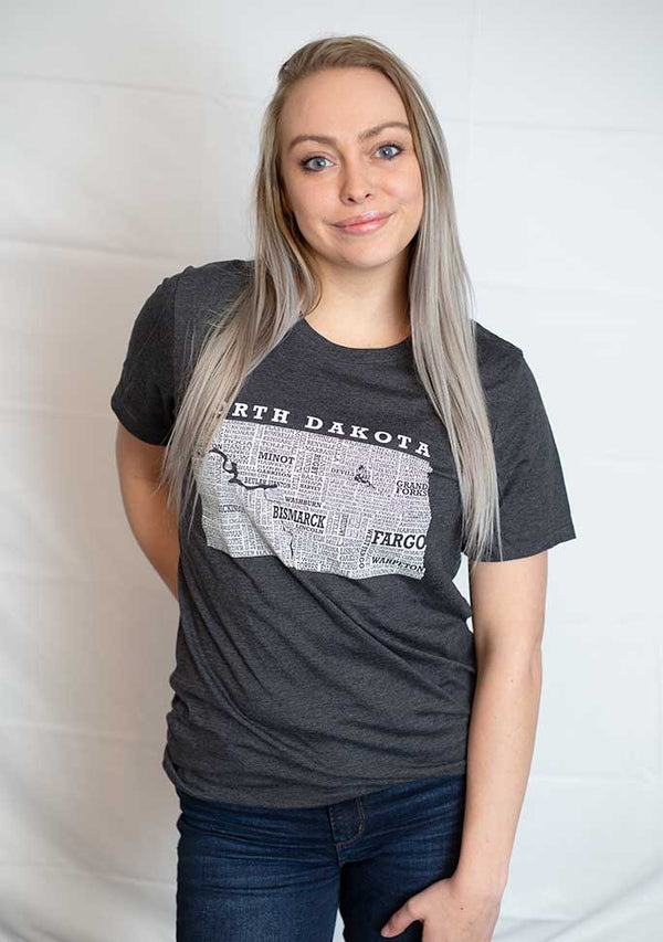 A unisex sized,Dark Grey Heather crew neck, short sleeve tee. Front white graphic is of North Dakota and its cities. Sizes small to 3X-Large. A Scratchpad Tees original design.