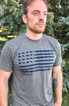 A Heather Military Green unisex crew neck tee shirt. The Navy colored front graphic resembles the U.S. flag with images of grazing Bison in the stars field. The words South Dakota are placed directly under the graphic.