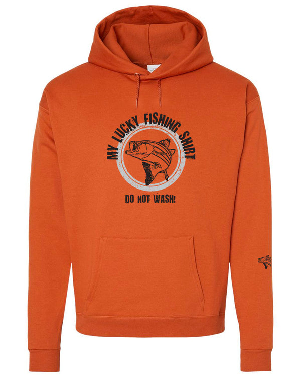 A mock up of a Texas Orange colored, hood, pouch front, unisex sized sweatshirt. The Large front graphic, done in light grey and black is of a large, active fish with a hook in its mouth. Wording, in an arc over and below the fish reads MY LUCKY FISHING SHIRT, DO NOT WASH! Available in sizes small to 3X-Large.