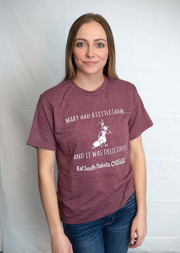 Heather Burgundy short sleeved tee with light grey graphic of Mary walking with her little lamb. The design reads Mary Had A Little Lamb, It Was Delicious. Eat South Dakota Chislic. Sizes Small to 3X-Large.                      