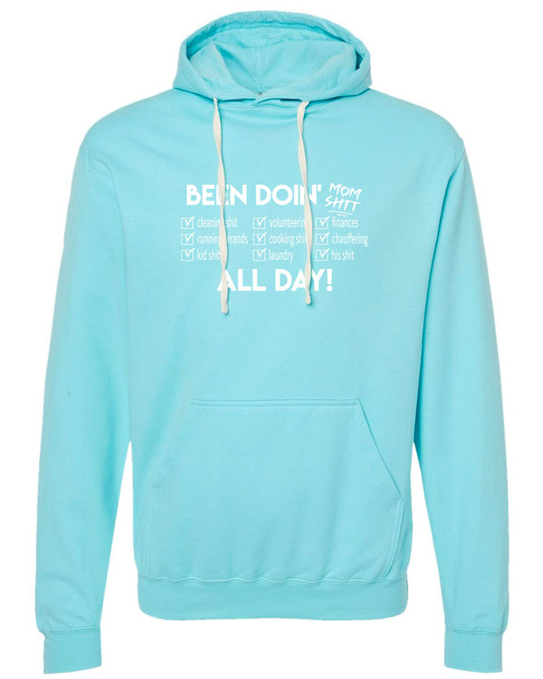 An Aqua Blue unisex hooded sweatshirt with a white graphic of 3 columns which describe nine tasks Mom's do. White graphic reads Been  Doin' Mom Shit All Day.