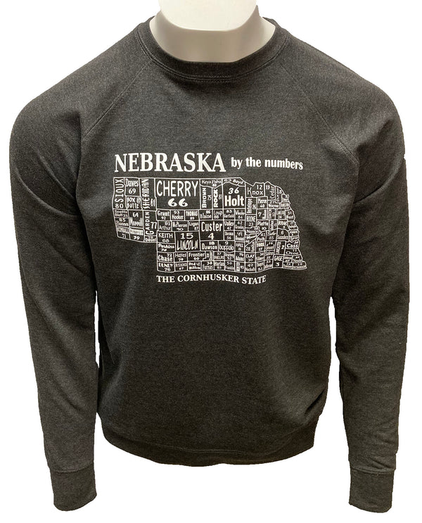 A male mannequin wearing a Charcoal Heather, unisex, crew neck sweatshirt. The white front graphic is a map of Nebraska's counties, by number and name. Wording reads Nebraska, The Cornhusker state. Available in sizes Small to 3 X-Large