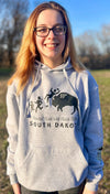 A mock up of a Heather Grey hooded, pouch front sweatshirt. The front graphic includes a charging buffalo launching a tourist family up in the air. The caption reads; Tossin' Tourists since 1889 in South Dakota.