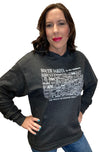 A woman wearing a Charcoal Heather, unisex, pouch front hooded sweatshirt. The white front graphic is a map of South Dakota's counties, by historical number and name. Wording reads South Dakota, The Mount Rushmore State. Available in sizes Small to 3 X-Large